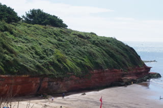 El acantilado rojo se asoma sobre la playa